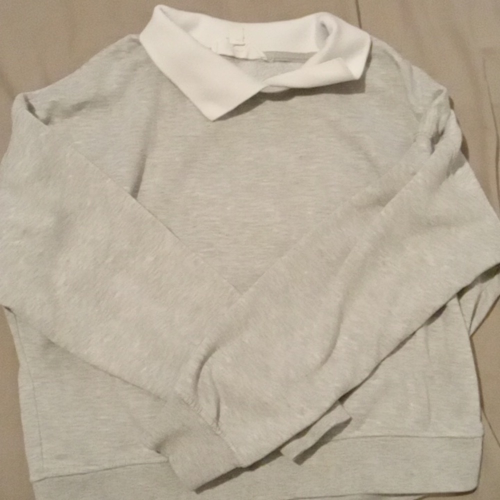 Long sleeved, grey sweater with white collar